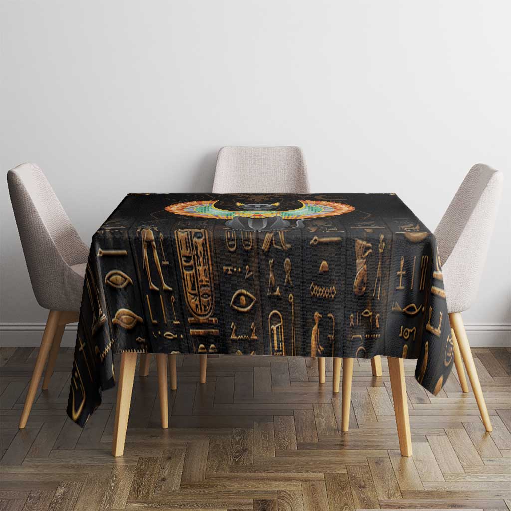 Black tablecloth featuring gold Egyptian icons and a colorful central winged cat