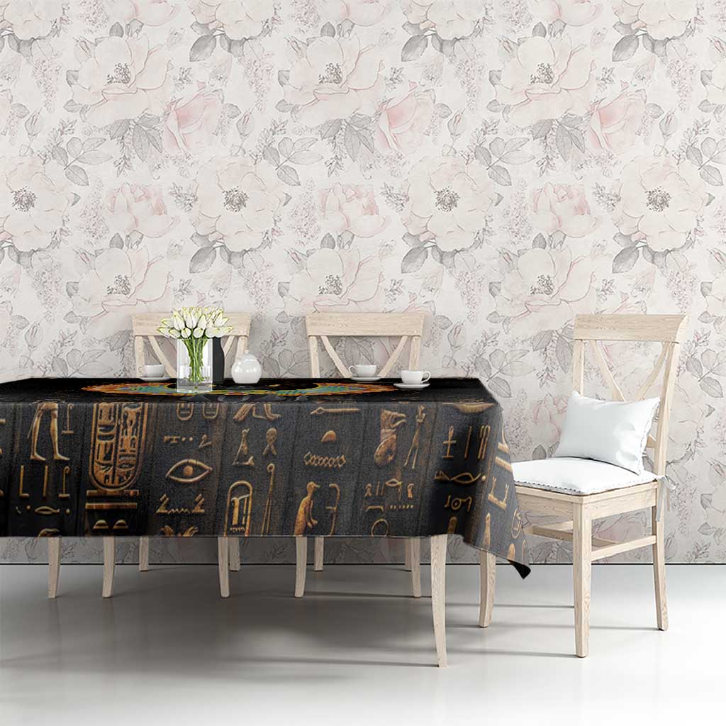 Black tablecloth with gold Egyptian motifs and winged cat centerpiece on table
