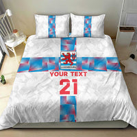 White duvet and pillow set with Luxembourg logo, red “YOUR TEXT” and large “21”