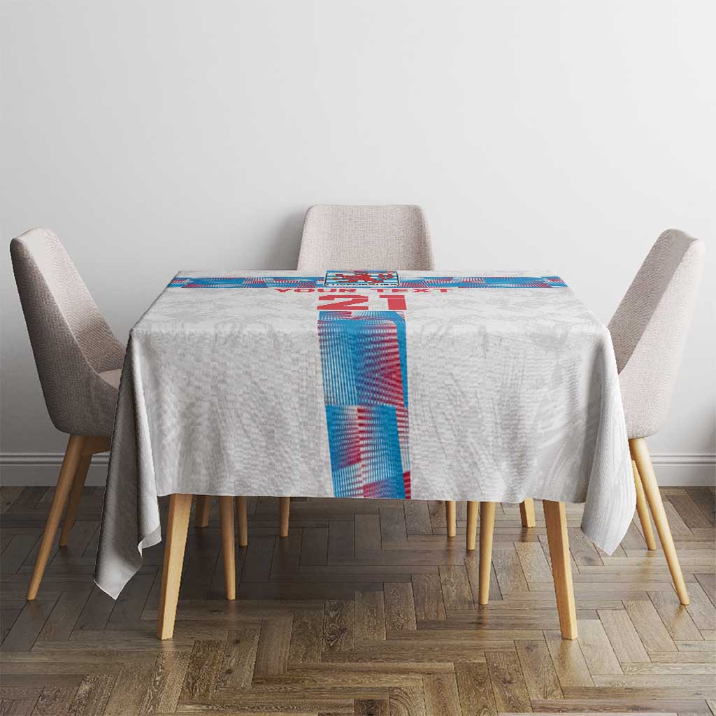 White tablecloth on a small table with blue-and-red vertical graphic panel