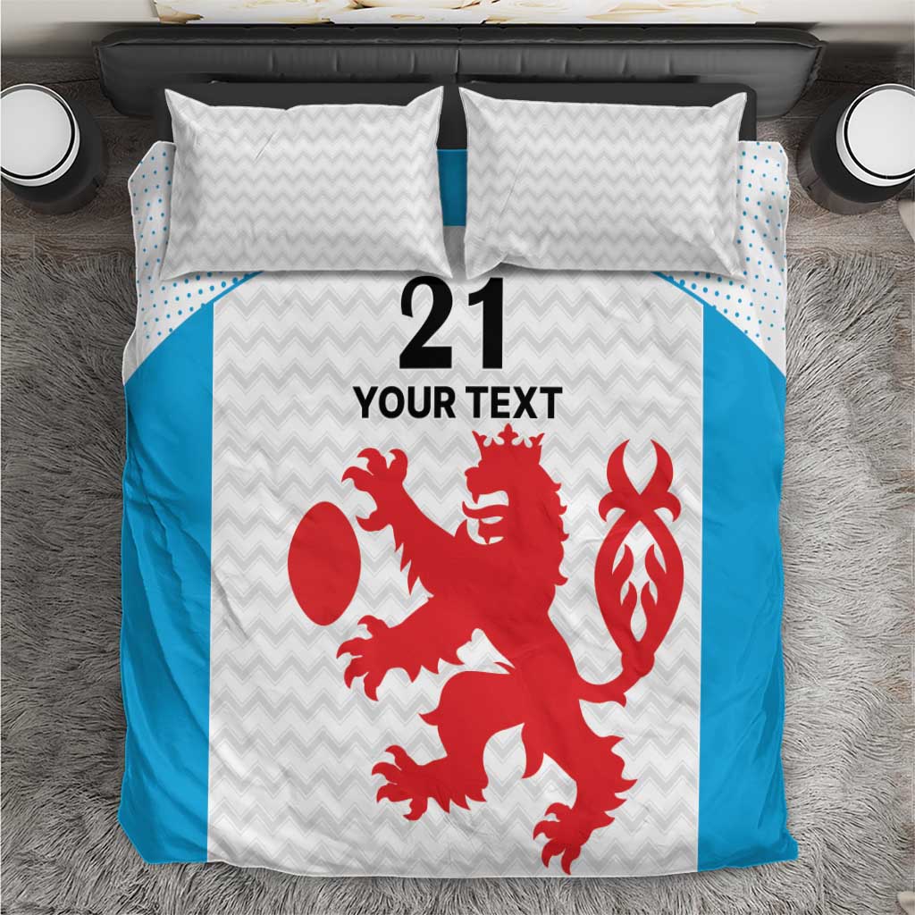 White and blue bedding set with red lion and crest graphic, matching chevron pillows
