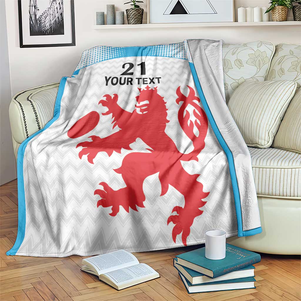 White custom blanket with blue dotted border, red crest and '21 YOUR TEXT' design