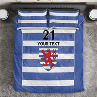 Blue and white striped bedding set with crest, number 21, and “YOUR TEXT” panel