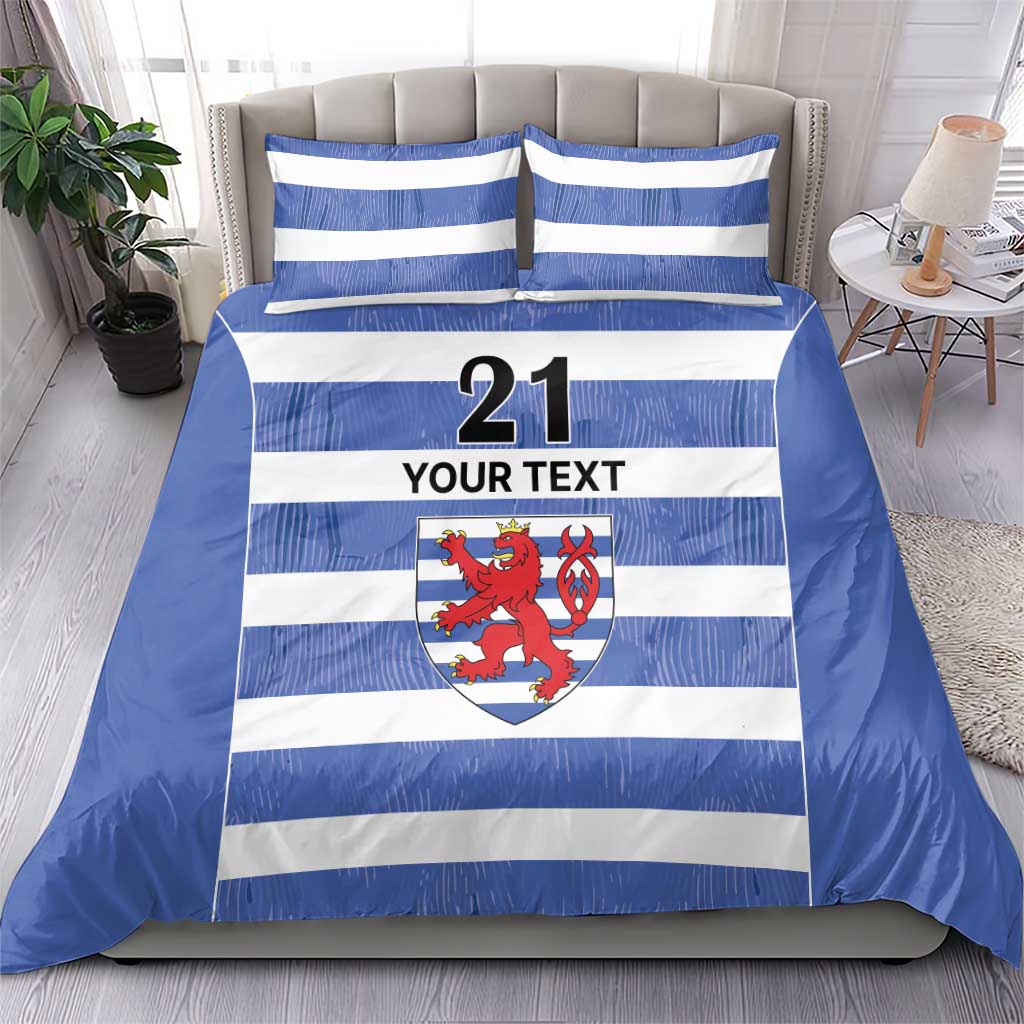 Blue and white striped duvet and pillow set with number 21, crest, and “YOUR TEXT”