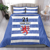 Blue and white striped duvet and pillow set with number 21, crest, and “YOUR TEXT”
