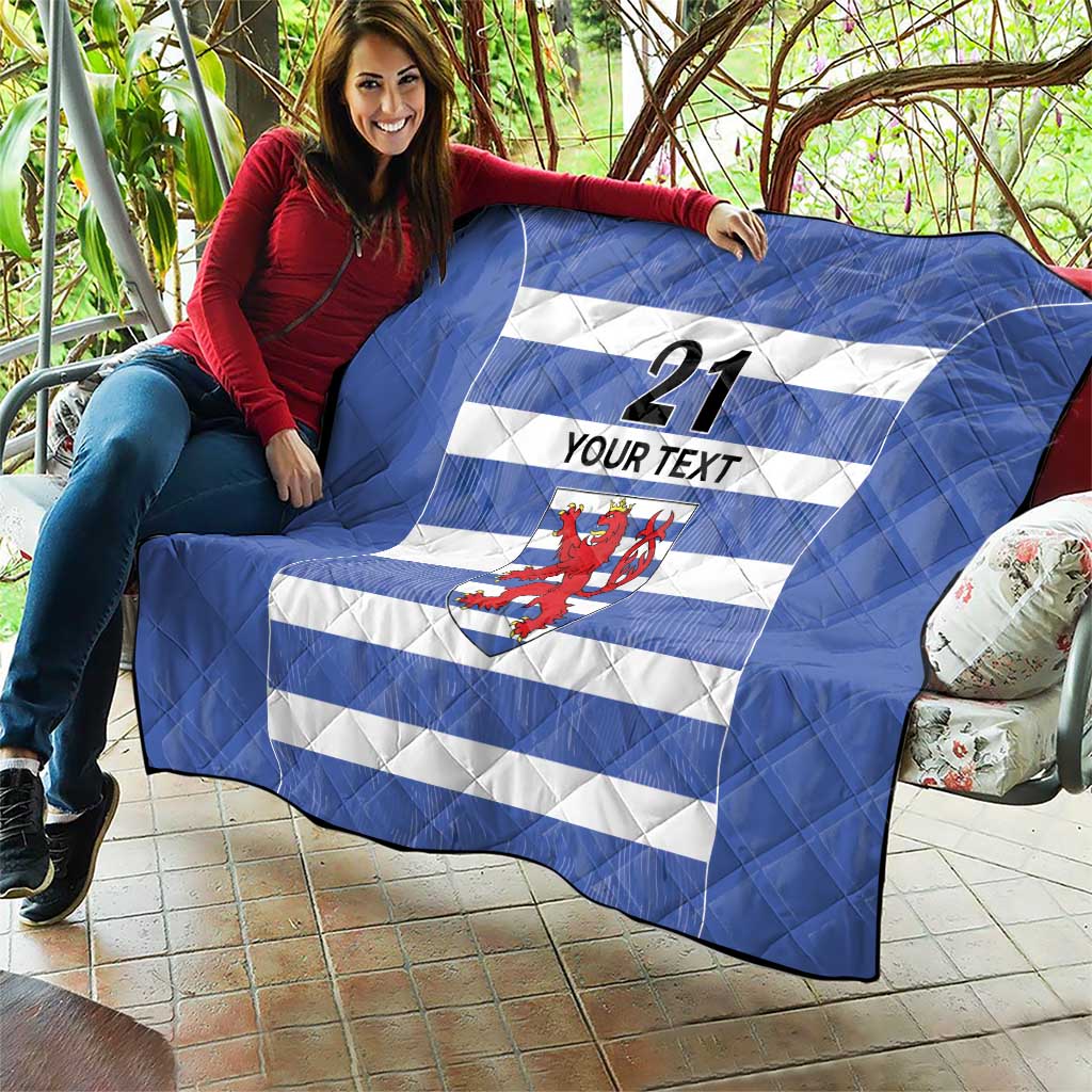 Blue quilt draped on patio seating, with white stripes, number 21, custom text, lion crest