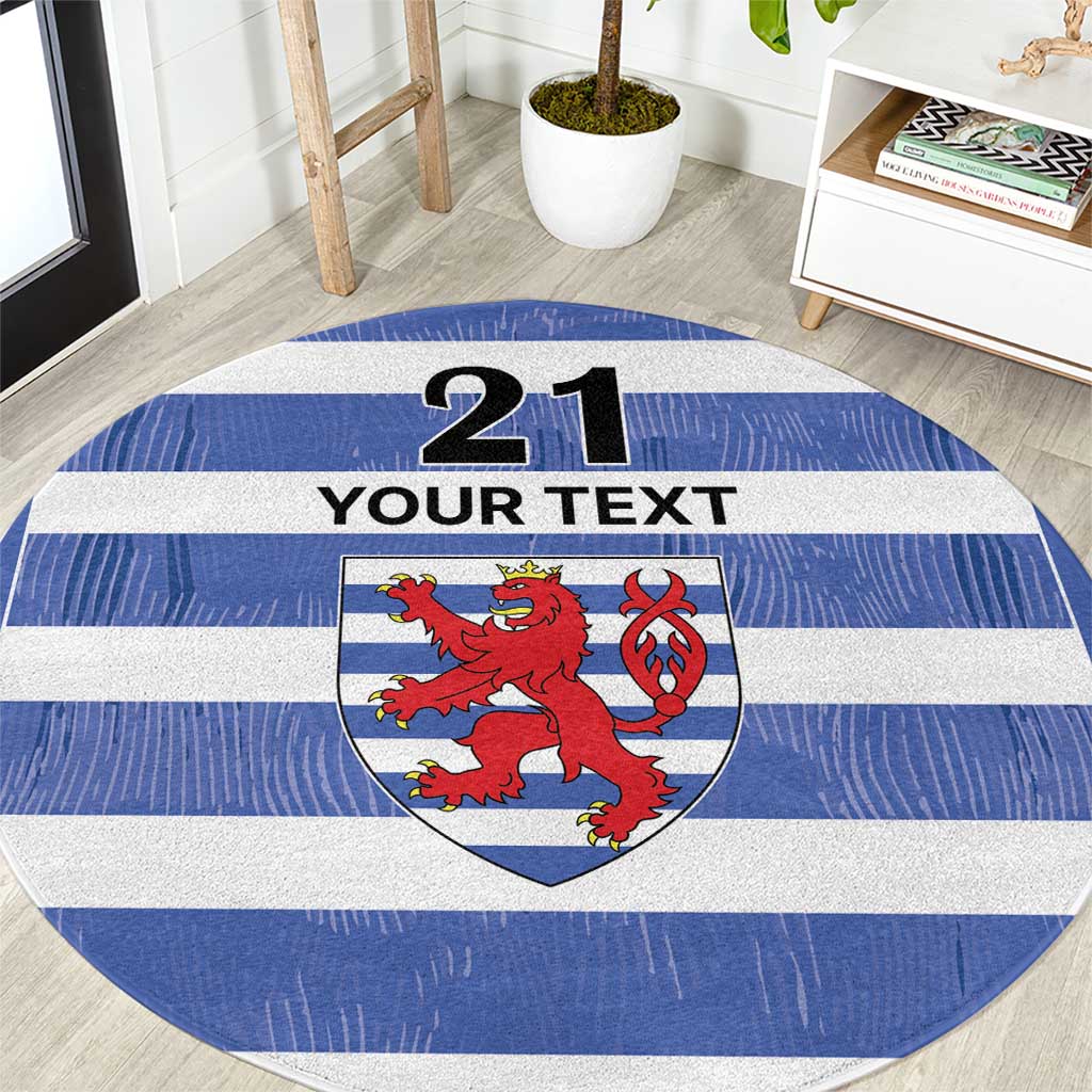 Blue striped round rug with lion crest, '21' and 'YOUR TEXT'.