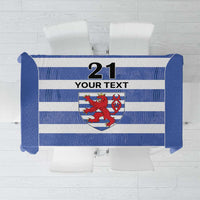 Blue tablecloth with rugby stripes and crest shield, blank banner