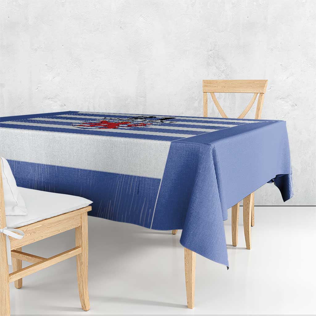 Blue tablecloth with striped rugby pattern and crest panel near the front edge