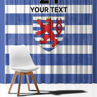 Close-up of blue and white striped curtain panel with red lion crest and custom text area.