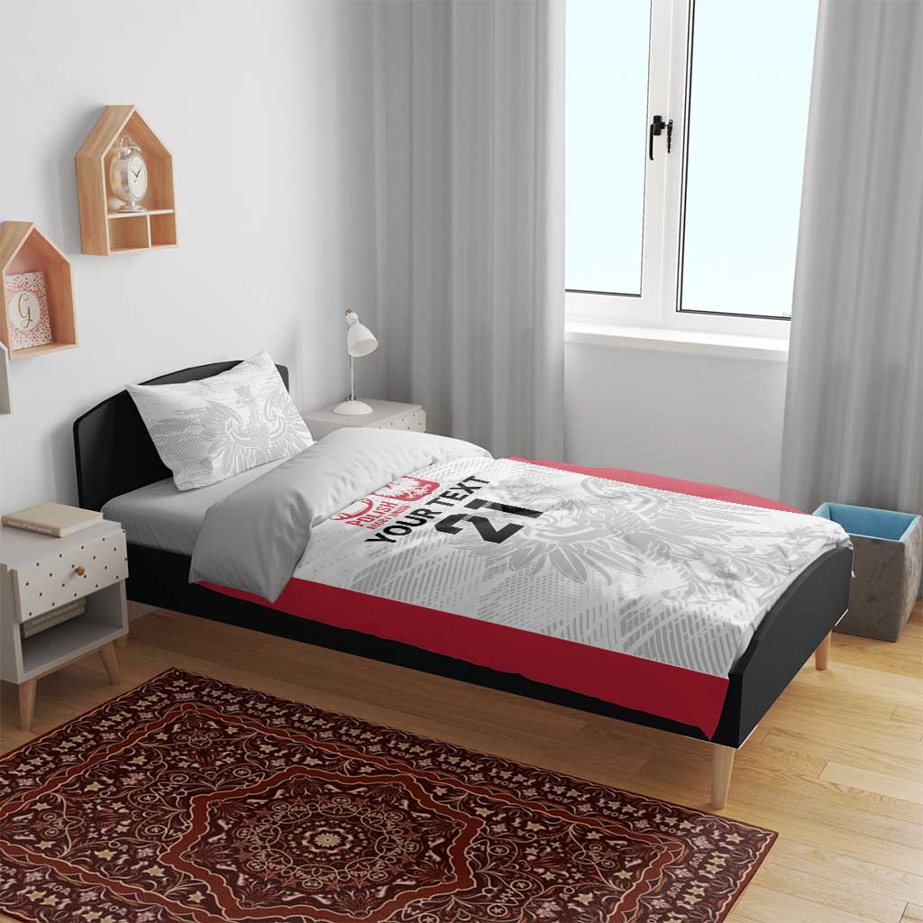 Rugby bedding set on bed: white duvet with red side panels, gray crest and 'YOUR TEXT 21'