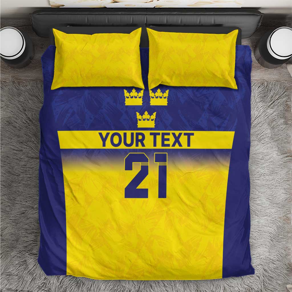 Blue and yellow bedding set with crown icons, “YOUR TEXT,” and large “21” on duvet