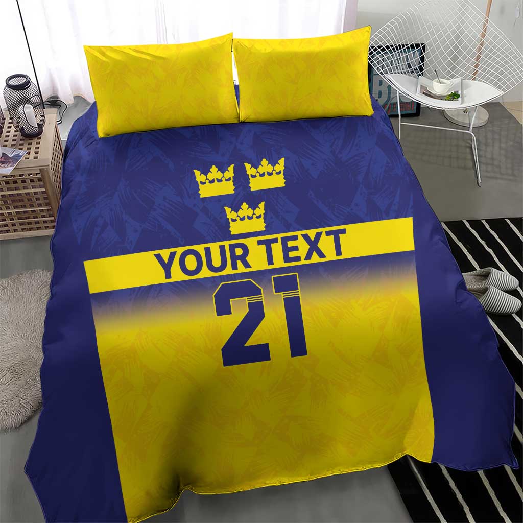 Blue and yellow bedding set with three crown symbols, “YOUR TEXT,” and “21” on duvet