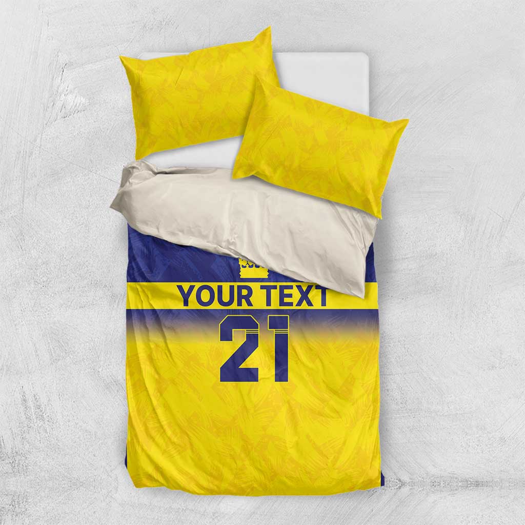 White base bedding set with yellow and blue duvet panel, crowns, “YOUR TEXT,” and “21”