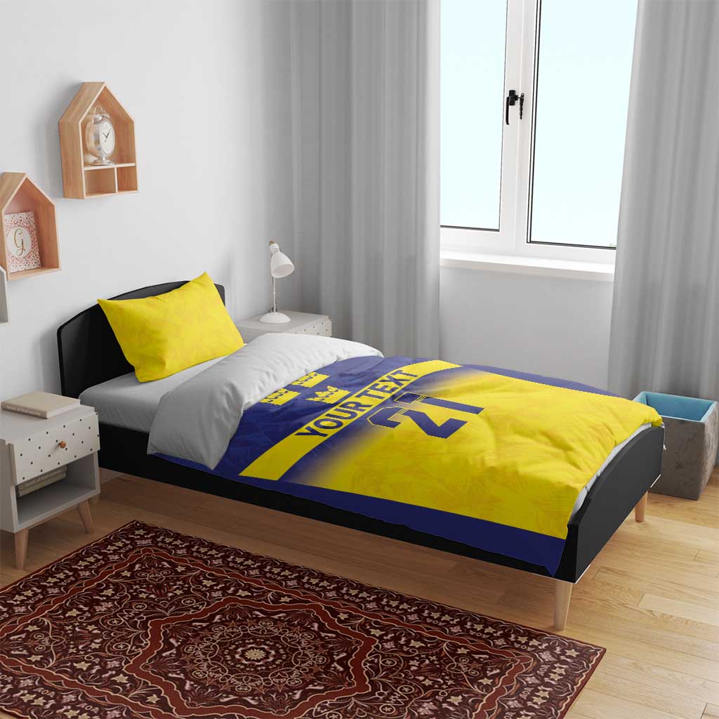 Blue and yellow bedding set with “YOUR TEXT” and “21” text and crown detail on duvet