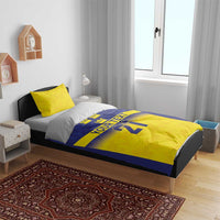 Blue and yellow bedding set with “YOUR TEXT” and “21” text and crown detail on duvet