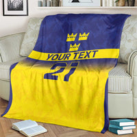 Custom rugby blanket with blue upper panel, yellow bottom, crowns, “YOUR TEXT,” and 21.