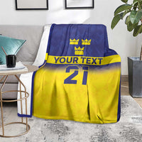 Blue and yellow custom rugby blanket with crowns, “YOUR TEXT,” and large number 21.
