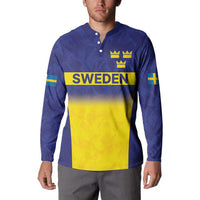 Blue rugby sweatshirt on model with button placket, long sleeves, crowns and Sweden front graphic