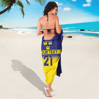 Blue and yellow sarong with crown symbols and big number 21, shown from back.