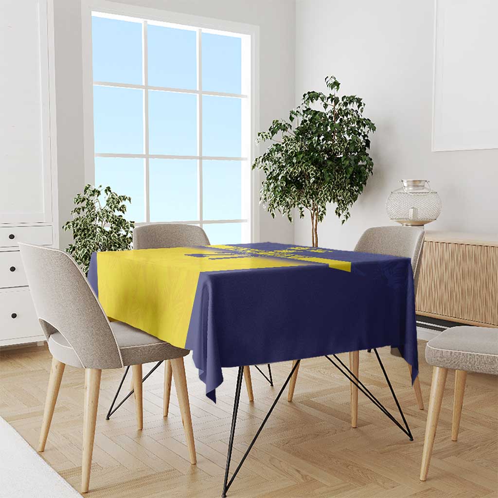 Square tablecloth in blue and yellow with crown and stripe pattern, draped on dining set