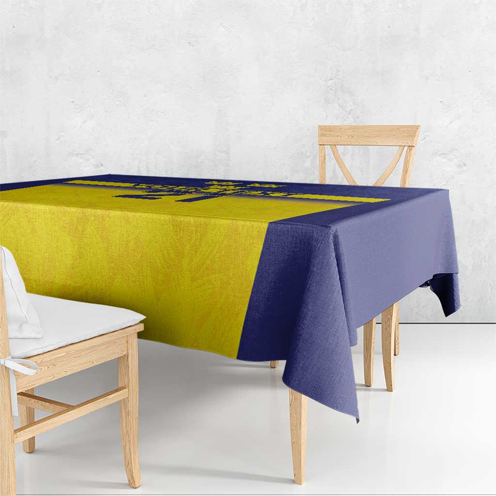 Blue and yellow tablecloth with crown and emblem border, side view with drop over edges