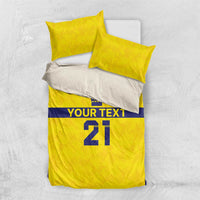 Gold and blue bedding set with 2 pillowcases; crowns, 'YOUR TEXT' banner, and '21'.