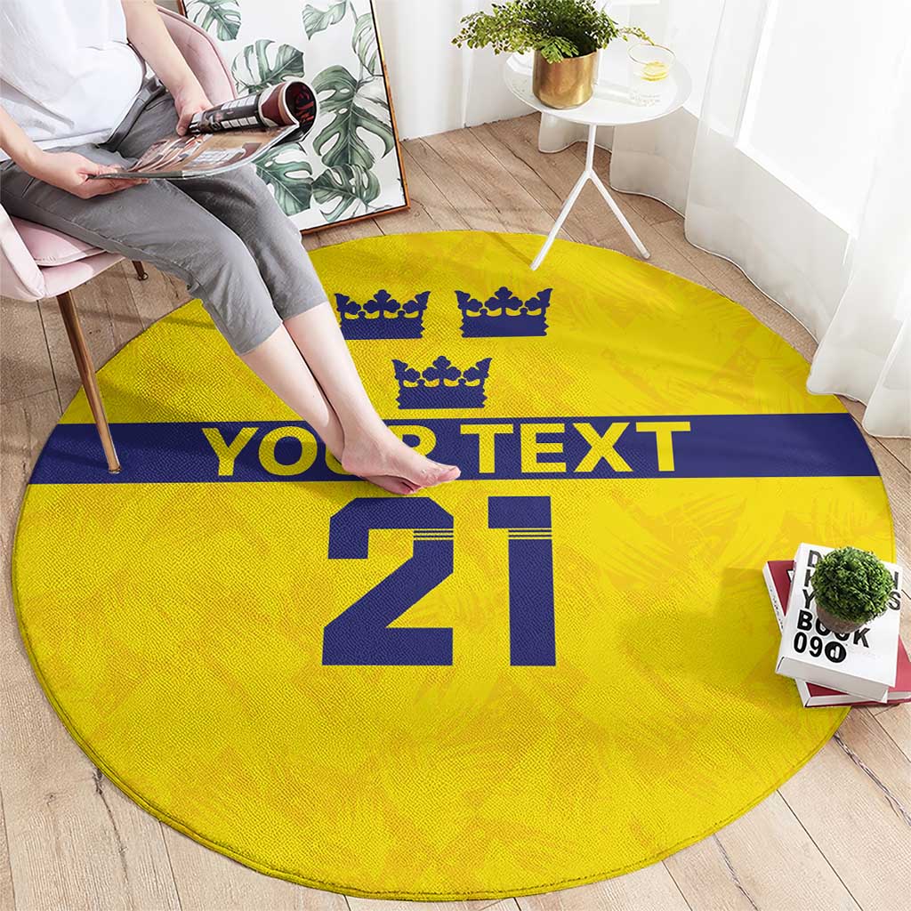 Yellow round rug with blue stripe, crowns, 'YOUR TEXT' band, and large '21'.