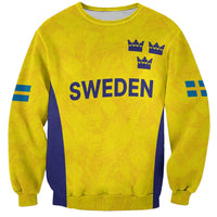 Unisex gold sweatshirt with blue Sweden text, three crowns, and Swedish flag stripes