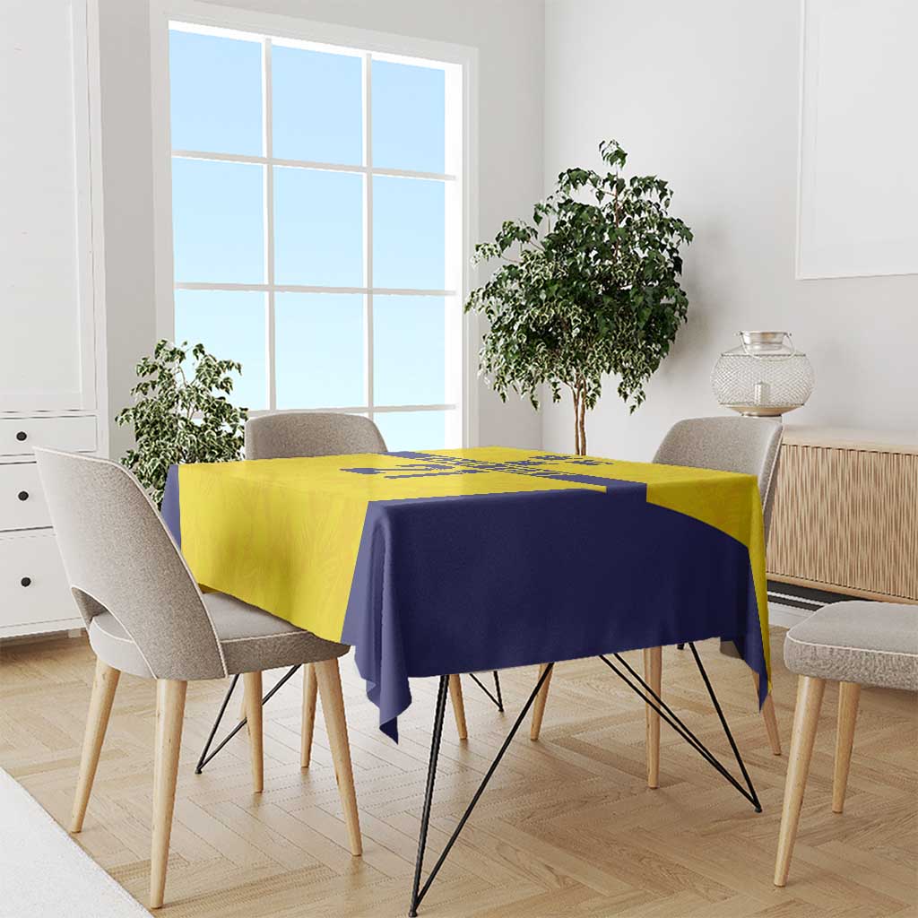 Gold and navy tablecloth draped on dining table with Swedish crown motif