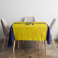 Gold and navy rectangle tablecloth with Swedish crown motif on dining table