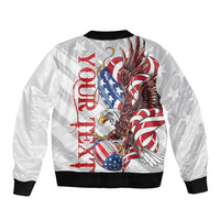 White bomber jacket with front zipper, black ribbed hem, large eagle and flag graphic
