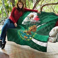 Green personalized quilt with Mexican flag eagle graphic, draped over outdoor seat, 'YOUR TEXT'