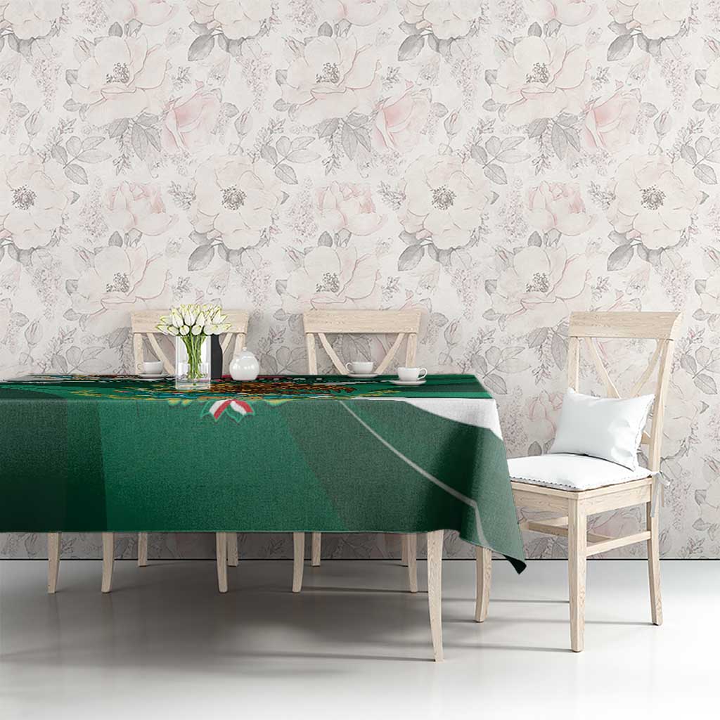 Green tablecloth with eagle-themed border and diagonal stripe design on dining setup.