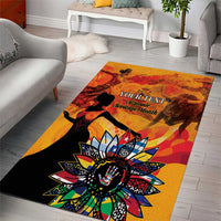 Gold and orange area rug with black figures, vibrant flower motif, and custom 'Your Text' text