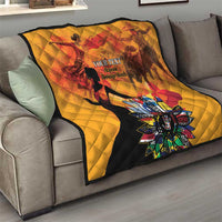 Gold quilt on a sofa with red and black dancer silhouettes and colorful flower centerpiece.