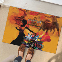 Personalized rubber doormat with gold artwork, black silhouettes, and large multicolor floral emblem