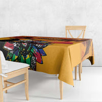 Gold tablecloth with vivid colorful graphic print over table surface