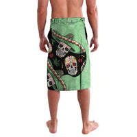 Green knee-length shorts with large sugar skull patch and cactus-pattern accents