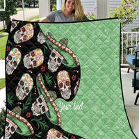 Green and black quilt with repeating sugar skull faces, leaf accents, and quilted diamond texture