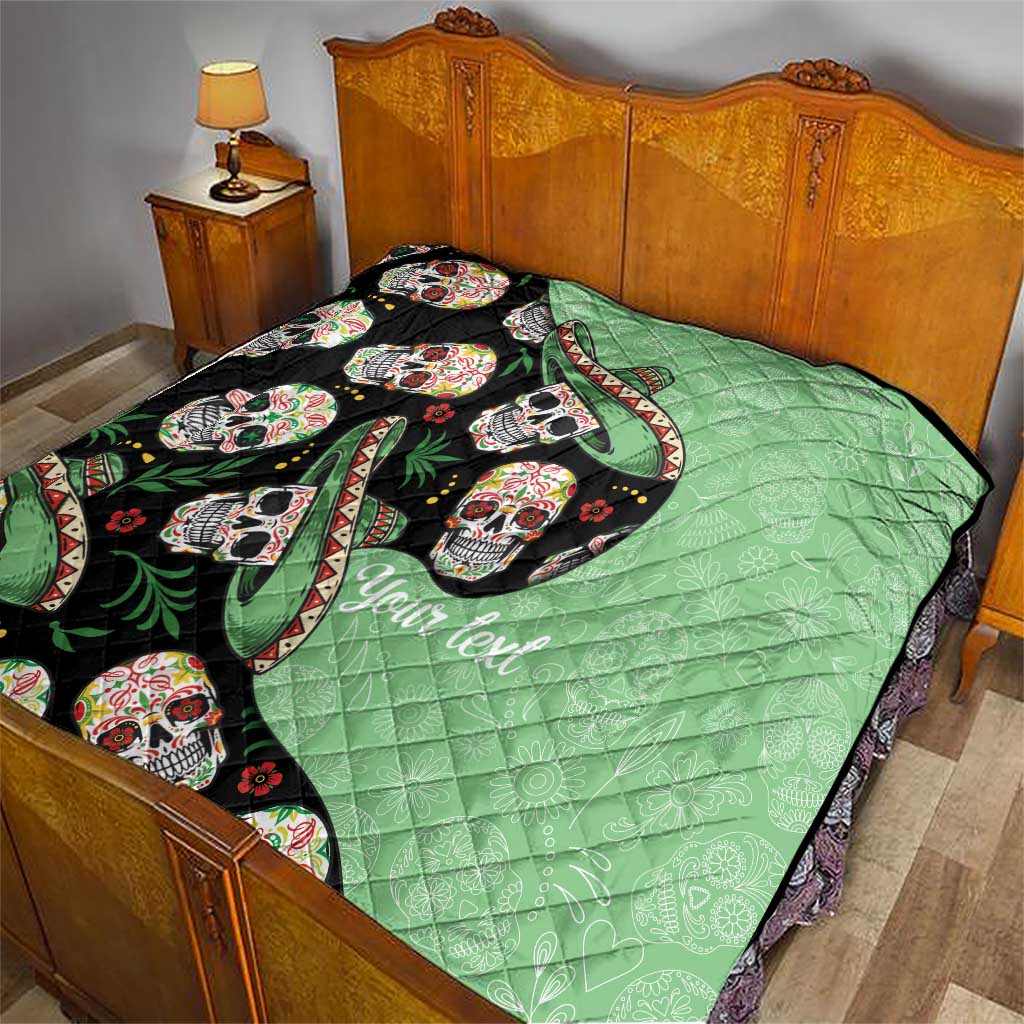 Green quilt with black sugar skull panel and leaf-and-ribbon graphics, set on a bed
