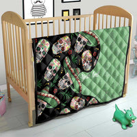 Green and black sugar skull quilt on a wooden baby bed, quilted diamond pattern