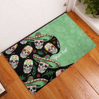 Green rubber doormat with black sugar skull pattern and “Your text”