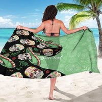 Green personalized sarong draped over shoulder, featuring sugar skull print and "Your text"