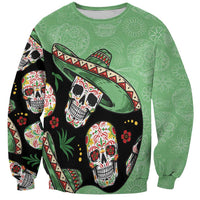 Green crewneck sweatshirt with colorful skulls and sombrero graphic