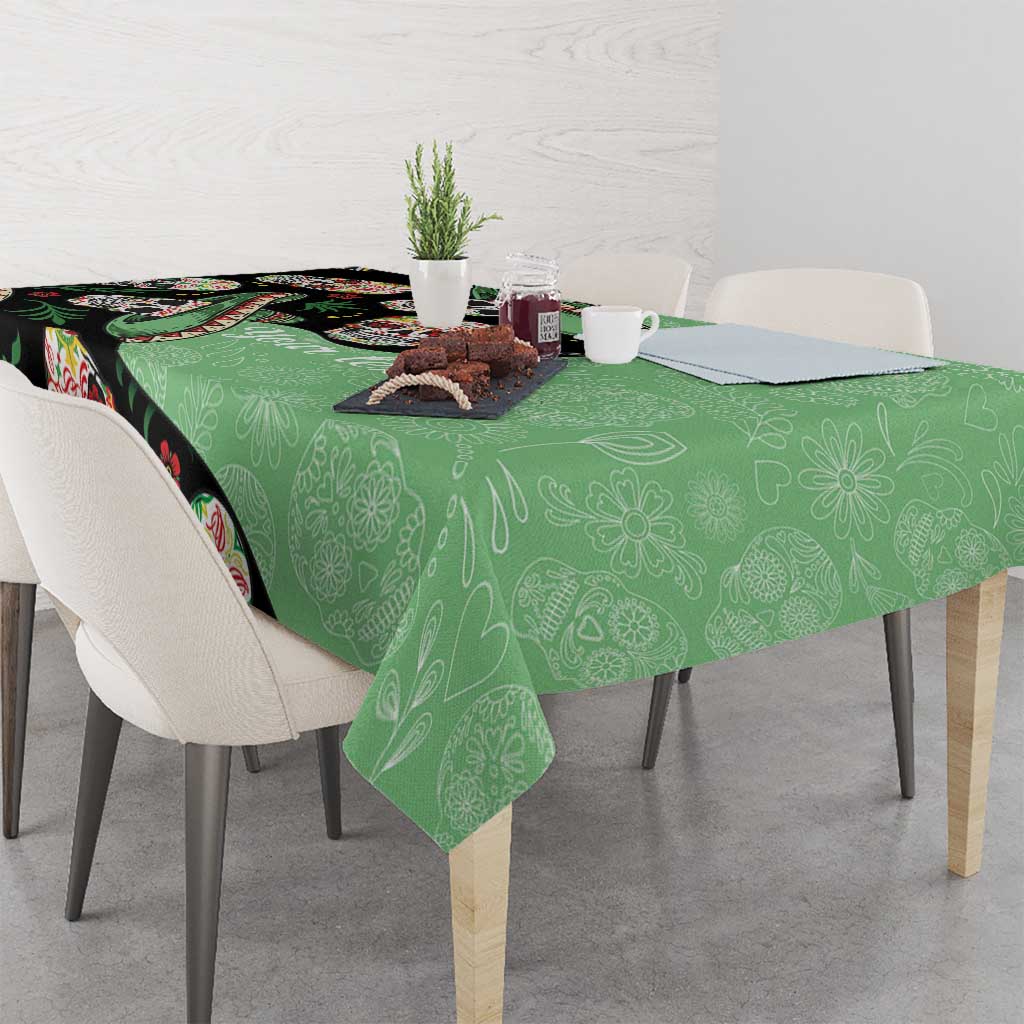 Green tablecloth with black sugar skull and floral skeleton pattern over dining table