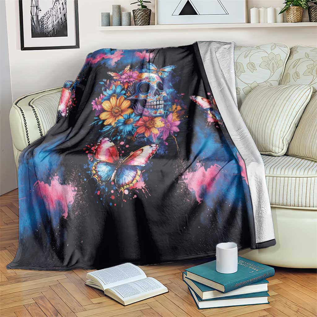 Black skull and butterfly day of the dead blanket draped over a sofa