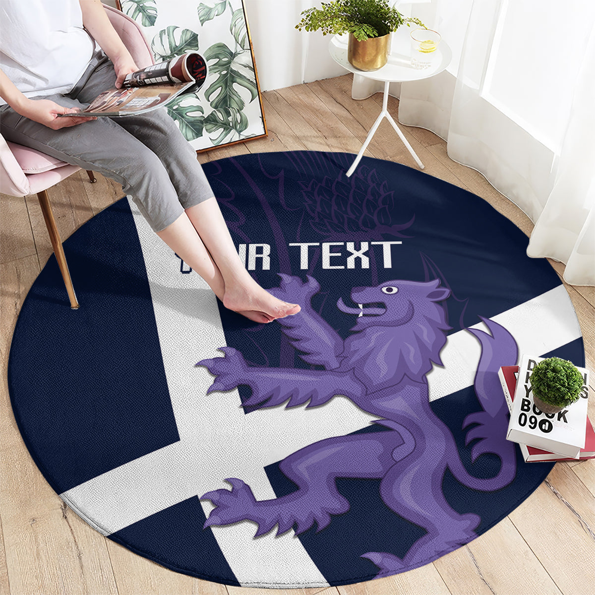 Navy round rug with white Scottish cross and purple lion graphic, partial 'YOUR TEXT'