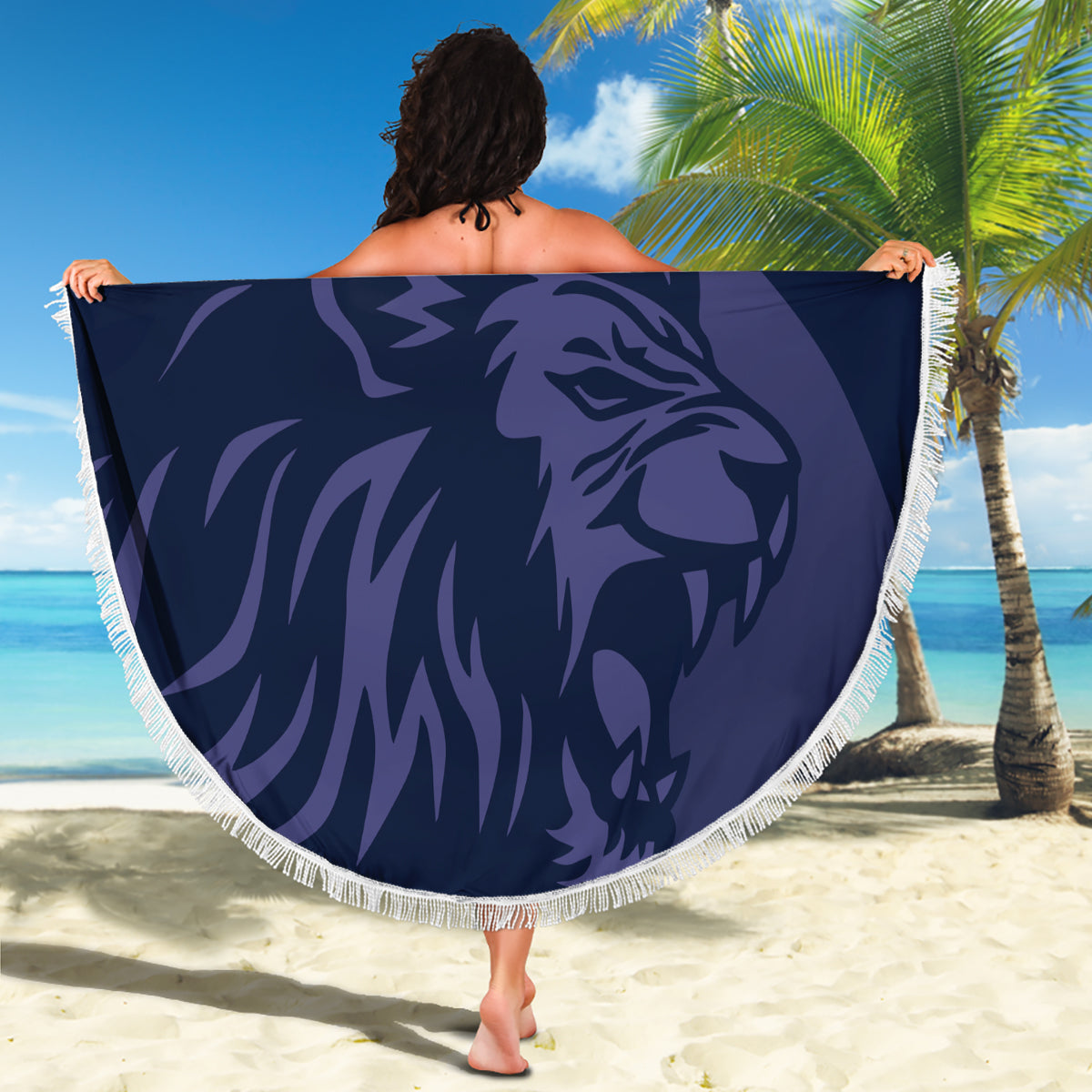 Navy round beach blanket with fringed border, lion graphic design held up outdoors