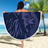 Navy round beach blanket with fringed border, lion graphic design held up outdoors
